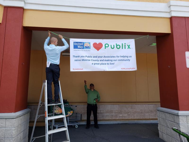 Two associates with a ladder helped us hang the banner.  Thanks guys!